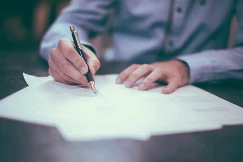 A man writing on a paper