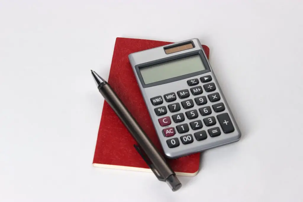 Silver calculator and a pen