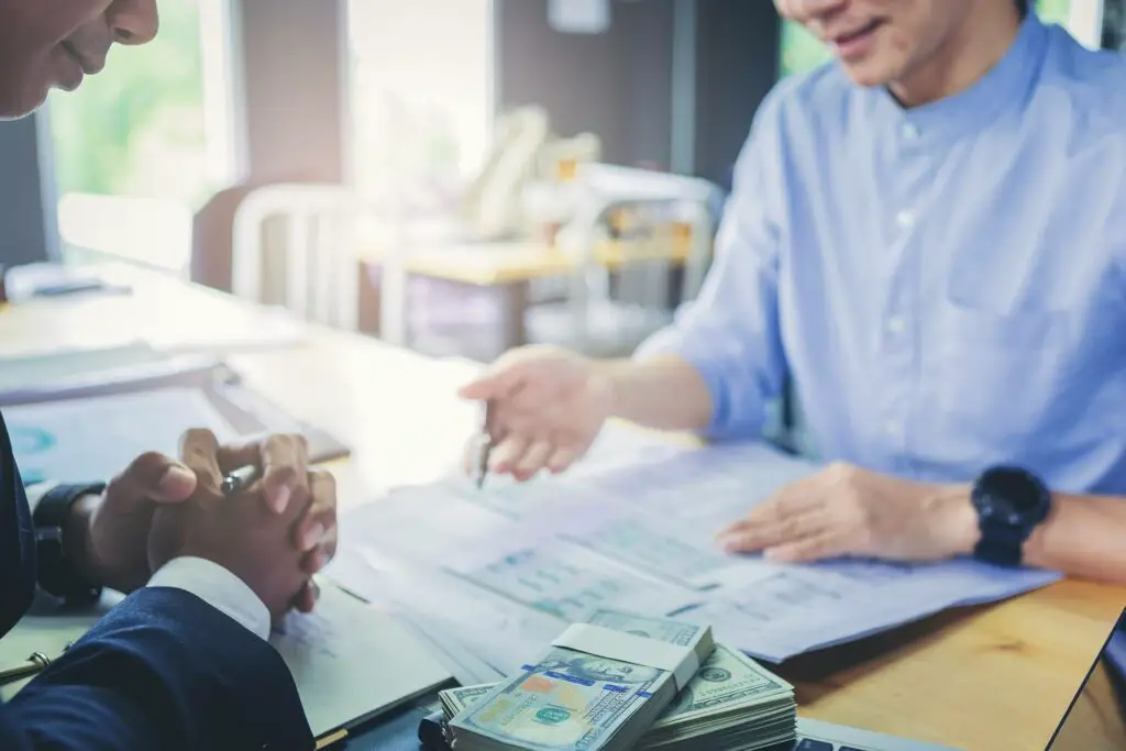 A man signing loan papers