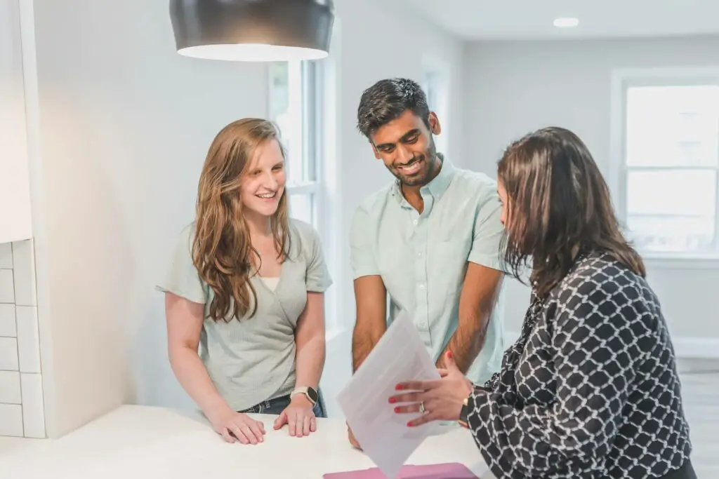 A couple talking to a real estate agent