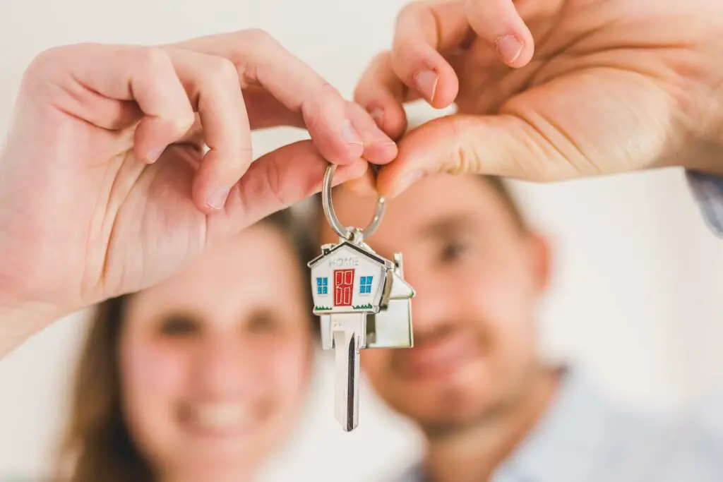 Woman and man holding a key 