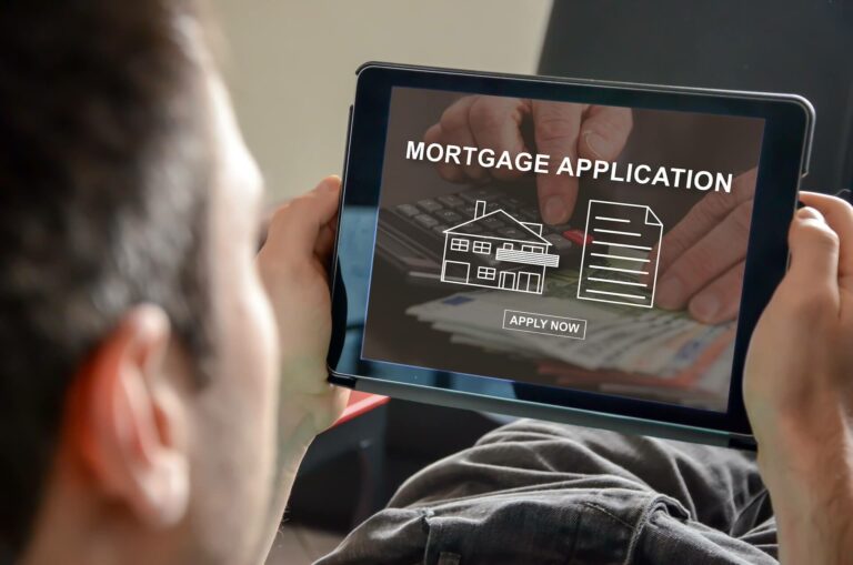 A man looking at a mortgage application online