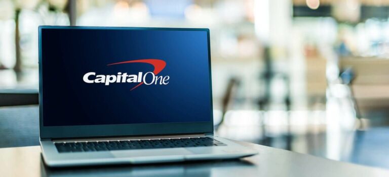 Laptop on the desk with a Capital One logo on the screen