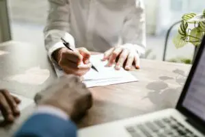 Two people signing a contract
