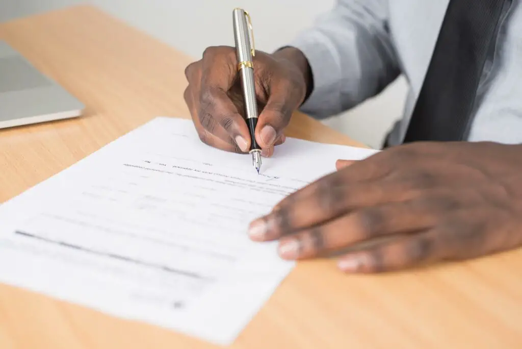 Person writing on a piece of paper