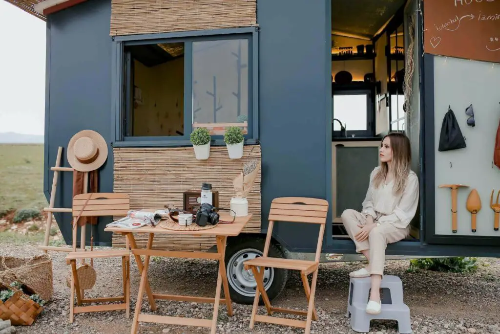 A girl sitting in front of her trailer