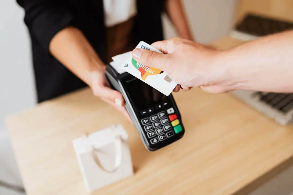 A man holding a card over a POS