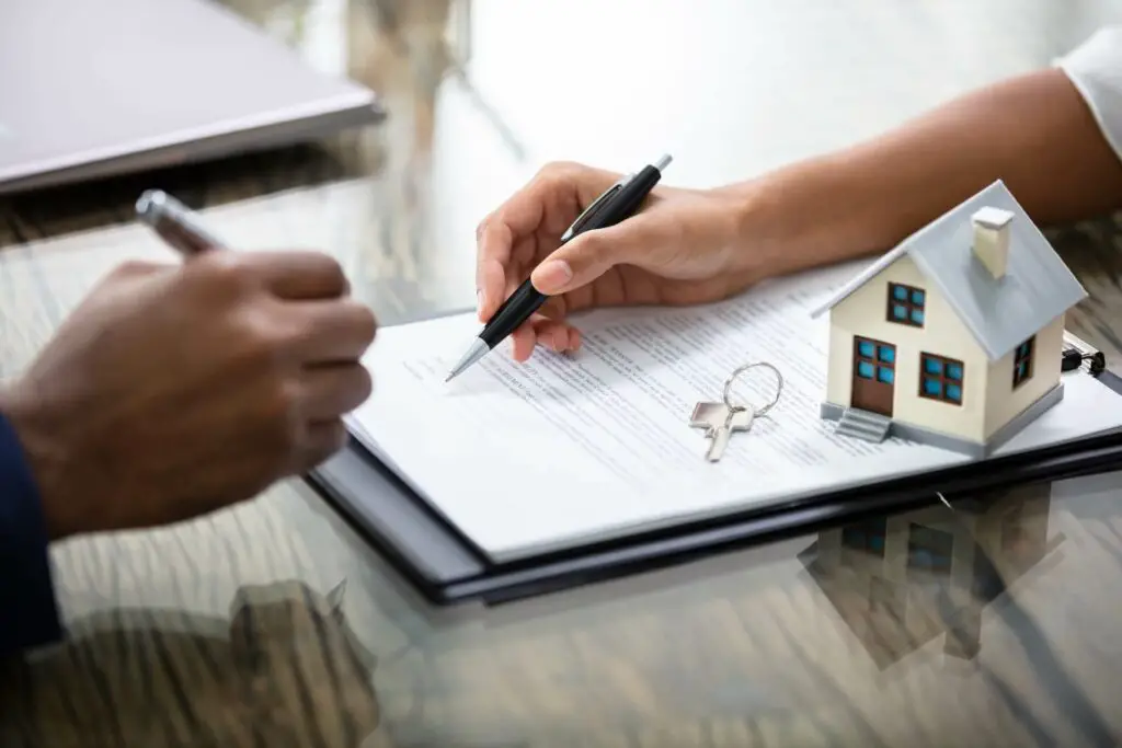 Woman signing papers for a house