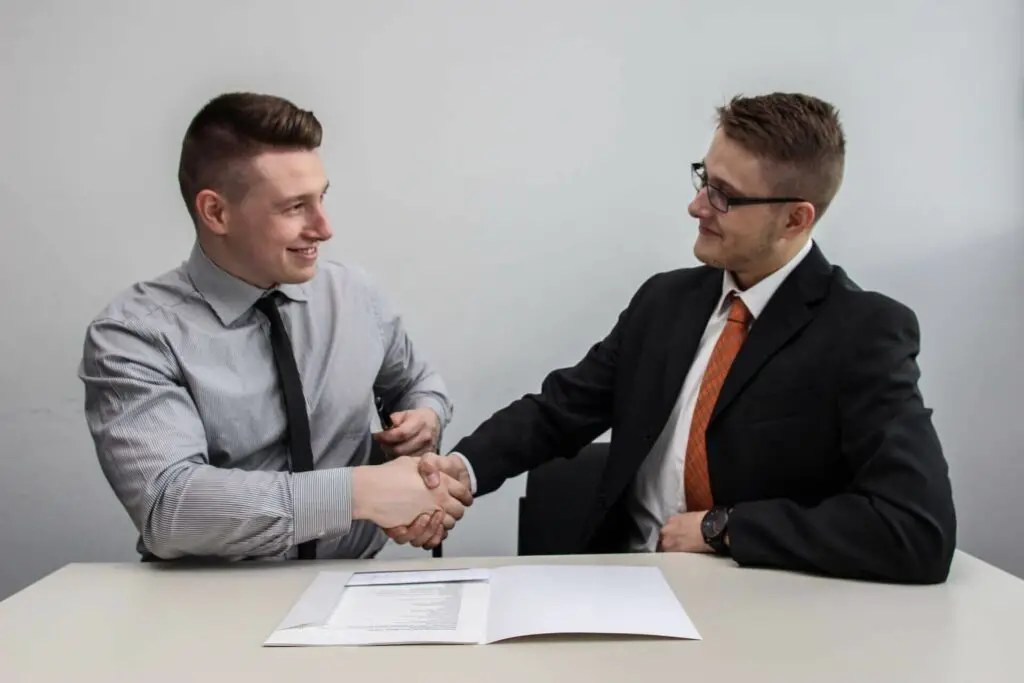 Two men handshaking after closing a deal