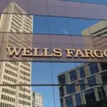 A glass building with a Wells Fargo sign