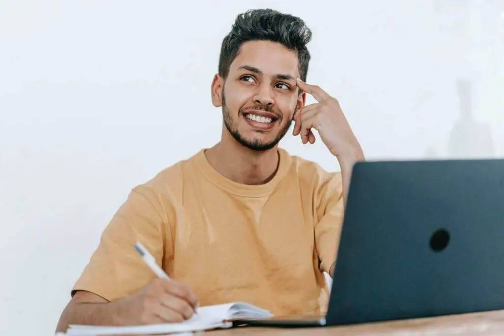 Man sitting in front of a laptop and thinking