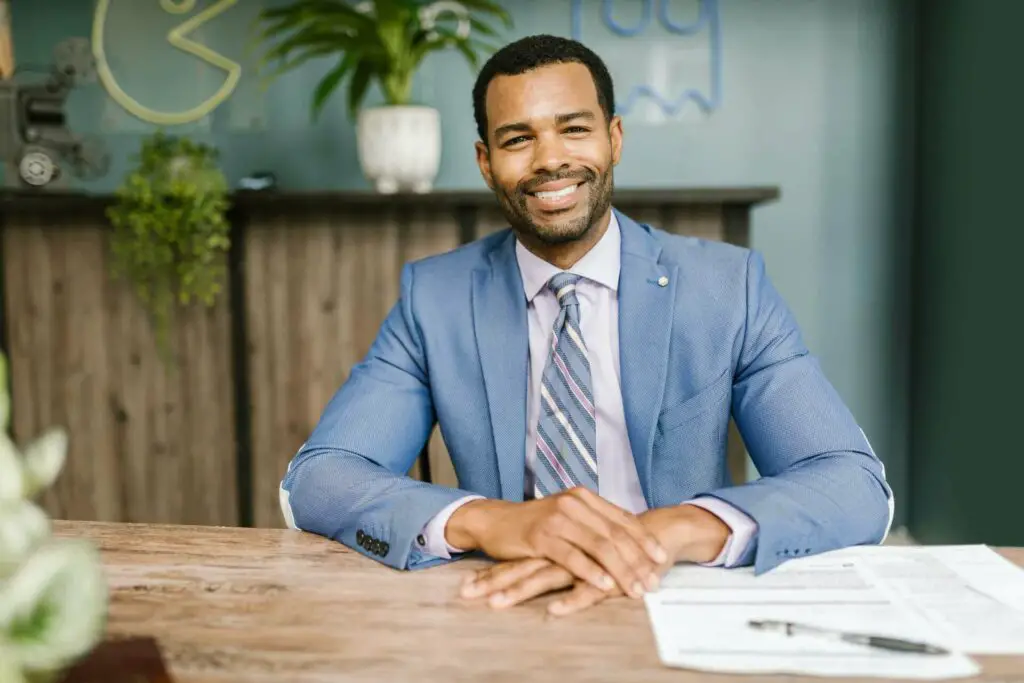 Man in a blue suit sitting and smiling