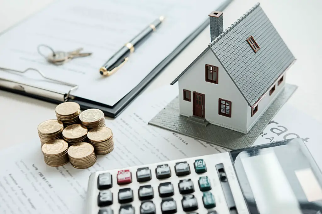  A model house, documents, and a calculator